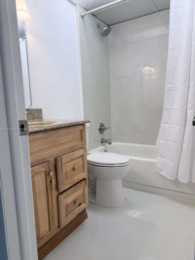 160 Southwest 30th Avenue, Unit 104A Miami, FL 33135 - Photo 5 of 32 a bathroom with a sink a toilet and shower