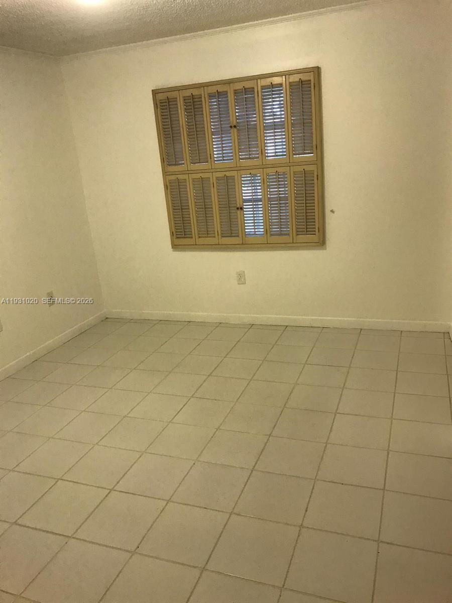160 Southwest 30th Avenue, Unit 104A Miami, FL 33135 - Photo 6 of 24 an empty room with windows