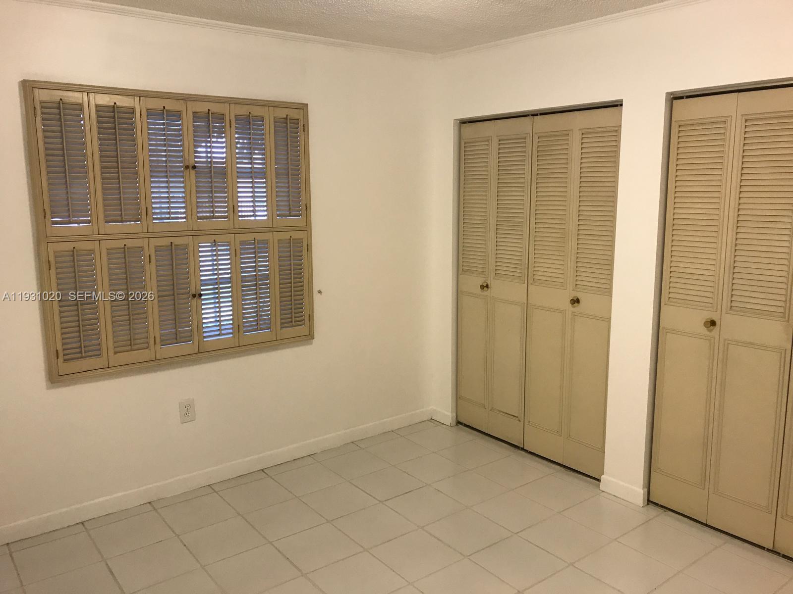 160 Southwest 30th Avenue, Unit 104A Miami, FL 33135 - Photo 7 of 24 an empty room with windows