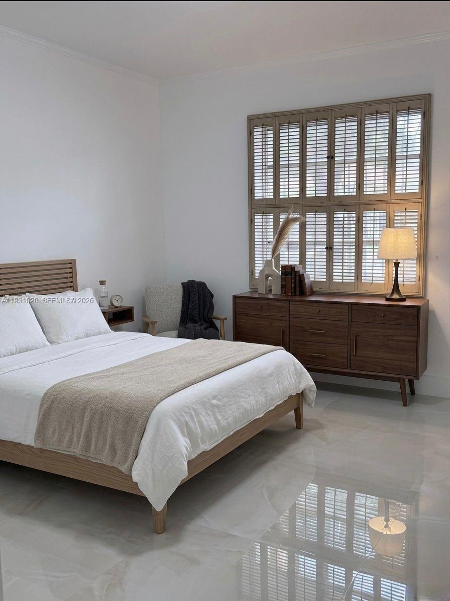 160 Southwest 30th Avenue, Unit 104A Miami, FL 33135 - Photo 7 of 32 a bedroom with a bed and a large window