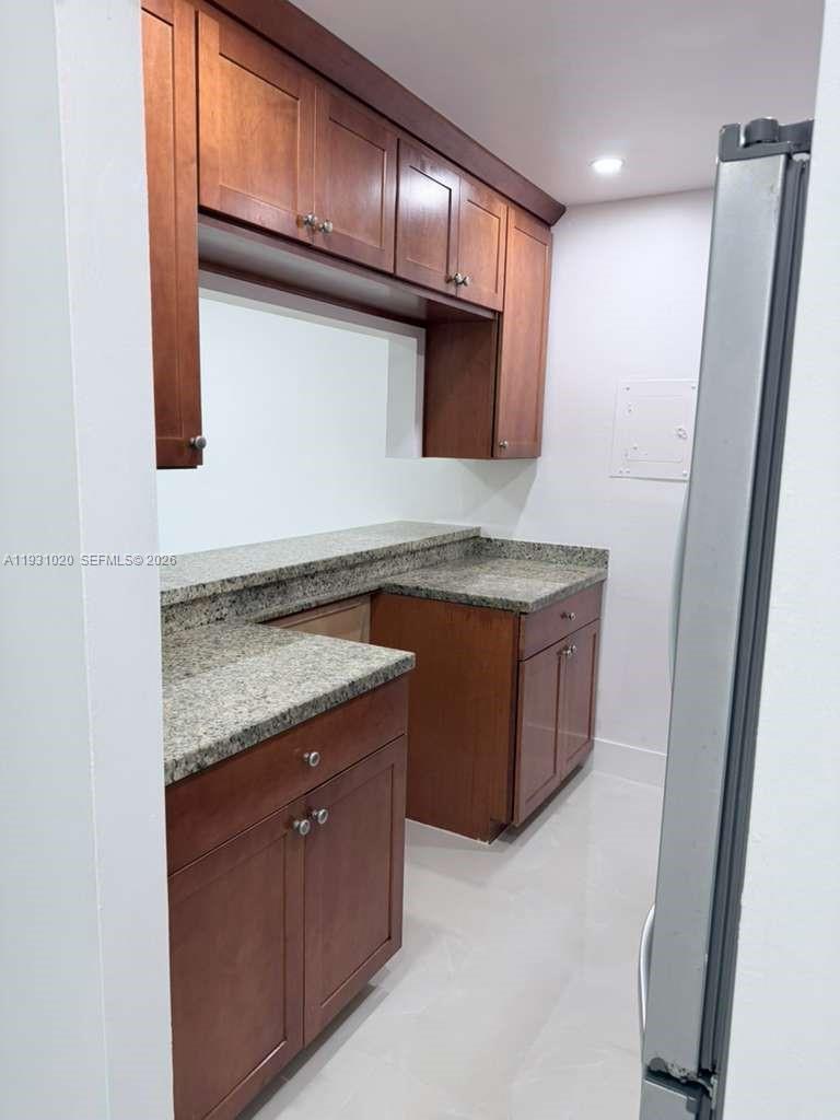 160 Southwest 30th Avenue, Unit 104A Miami, FL 33135 - Photo 9 of 32 a bathroom with a granite countertop sink and a mirror