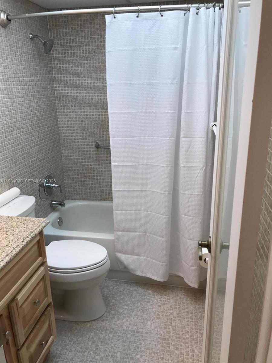 160 Southwest 30th Avenue, Unit 104A Miami, FL 33135 - Photo 10 of 24 a bathroom with a sink a toilet and shower