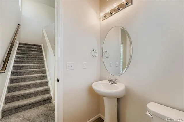 a bathroom with a sink a mirror and toilet