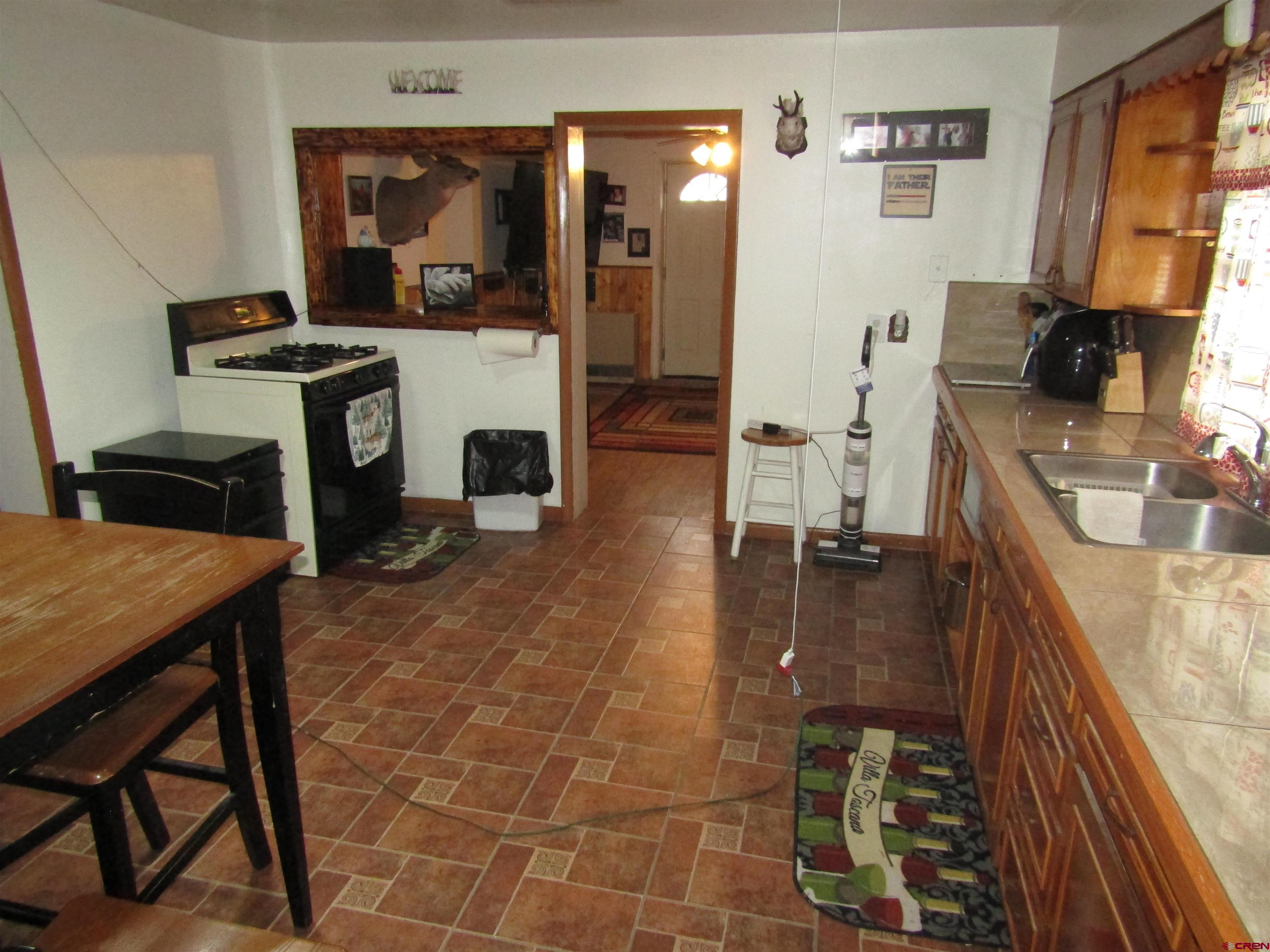 412 Lariat Road Monte Vista, CO 81144 - Photo 2 of 12 a living room with furniture a flat screen tv and a fireplace