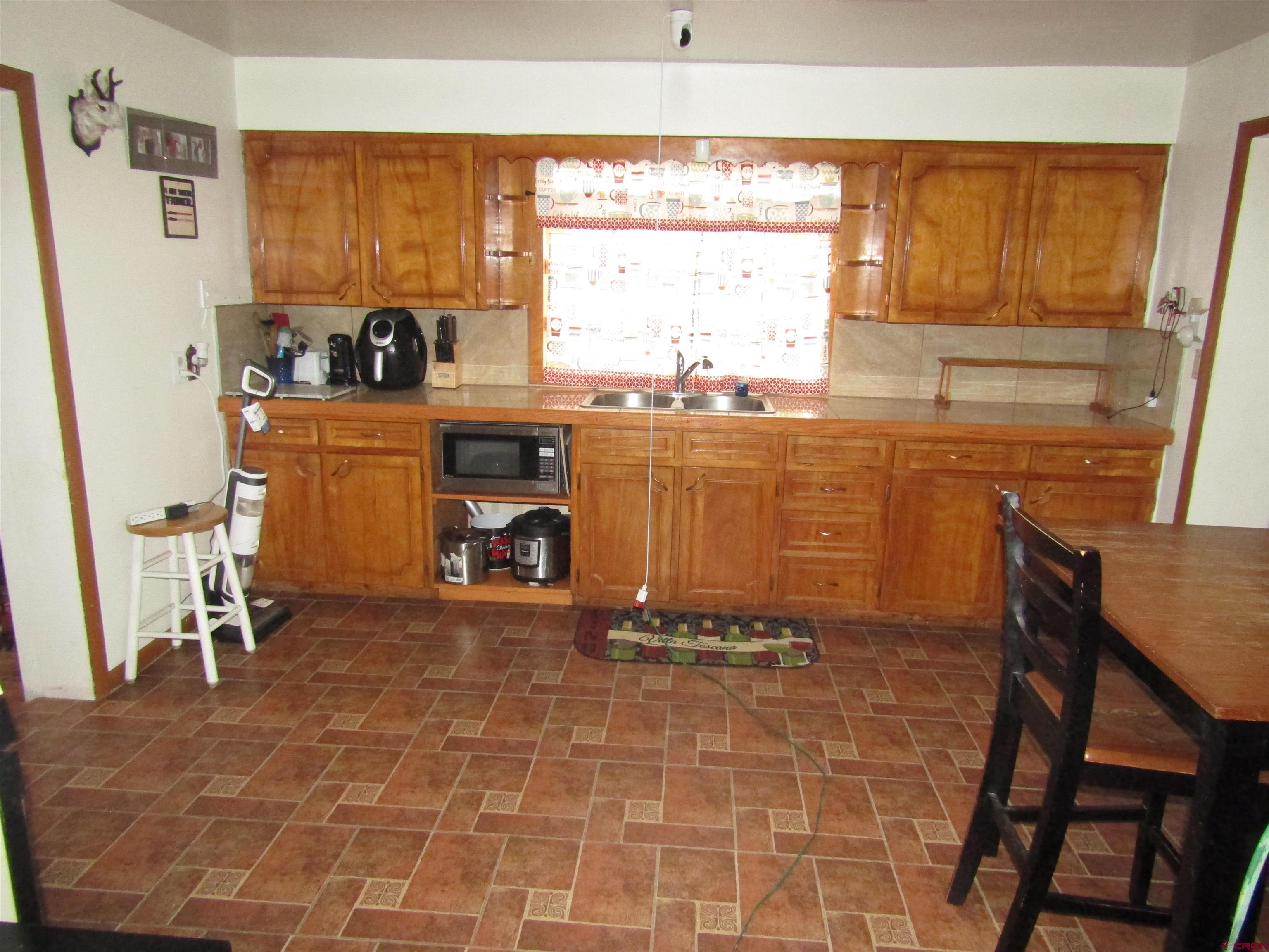 412 Lariat Road Monte Vista, CO 81144 - Photo 3 of 12 a room with table chairs and a refrigerator