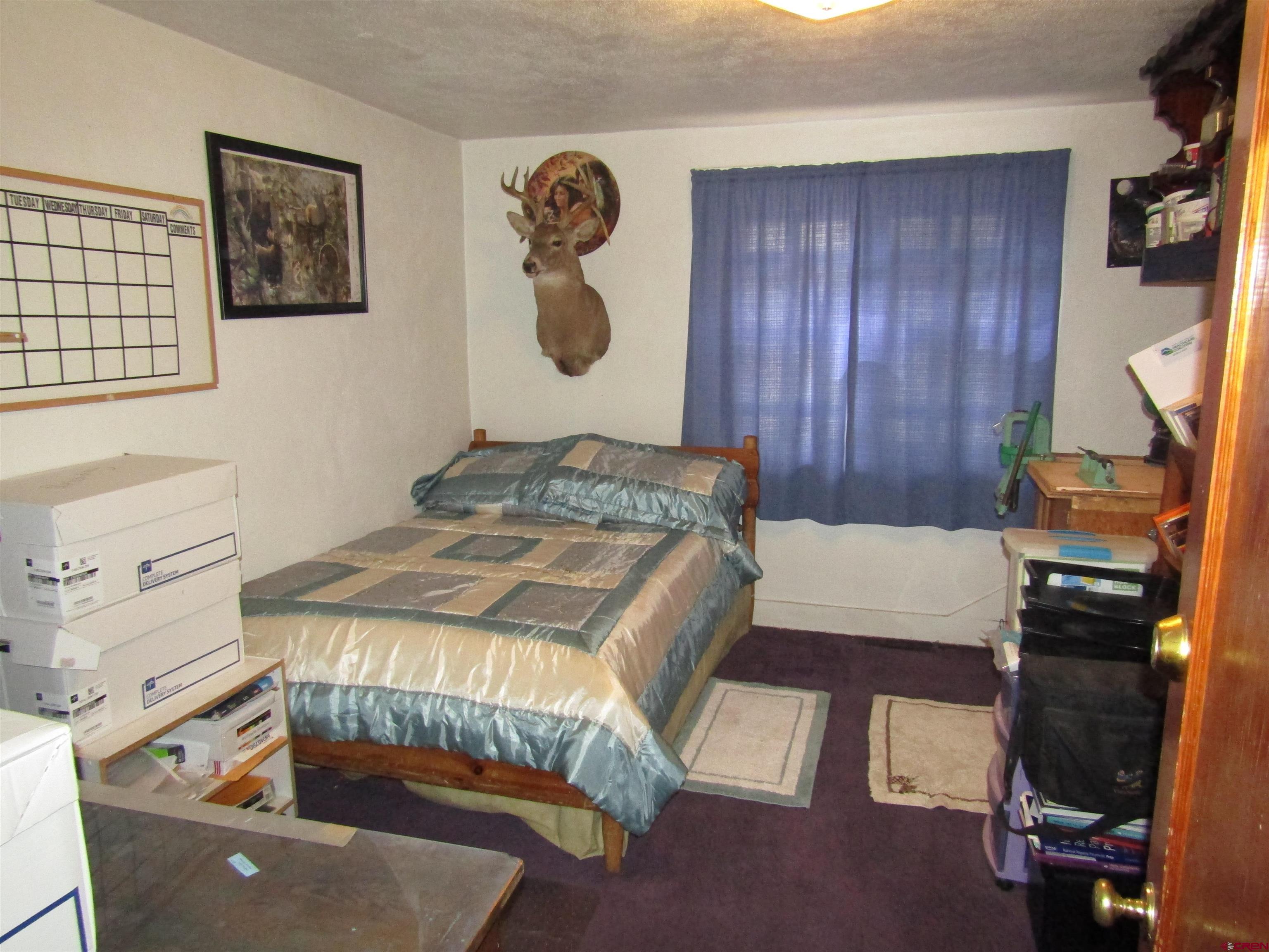 412 Lariat Road Monte Vista, CO 81144 - Photo 7 of 12 a bedroom with a bed and furniture