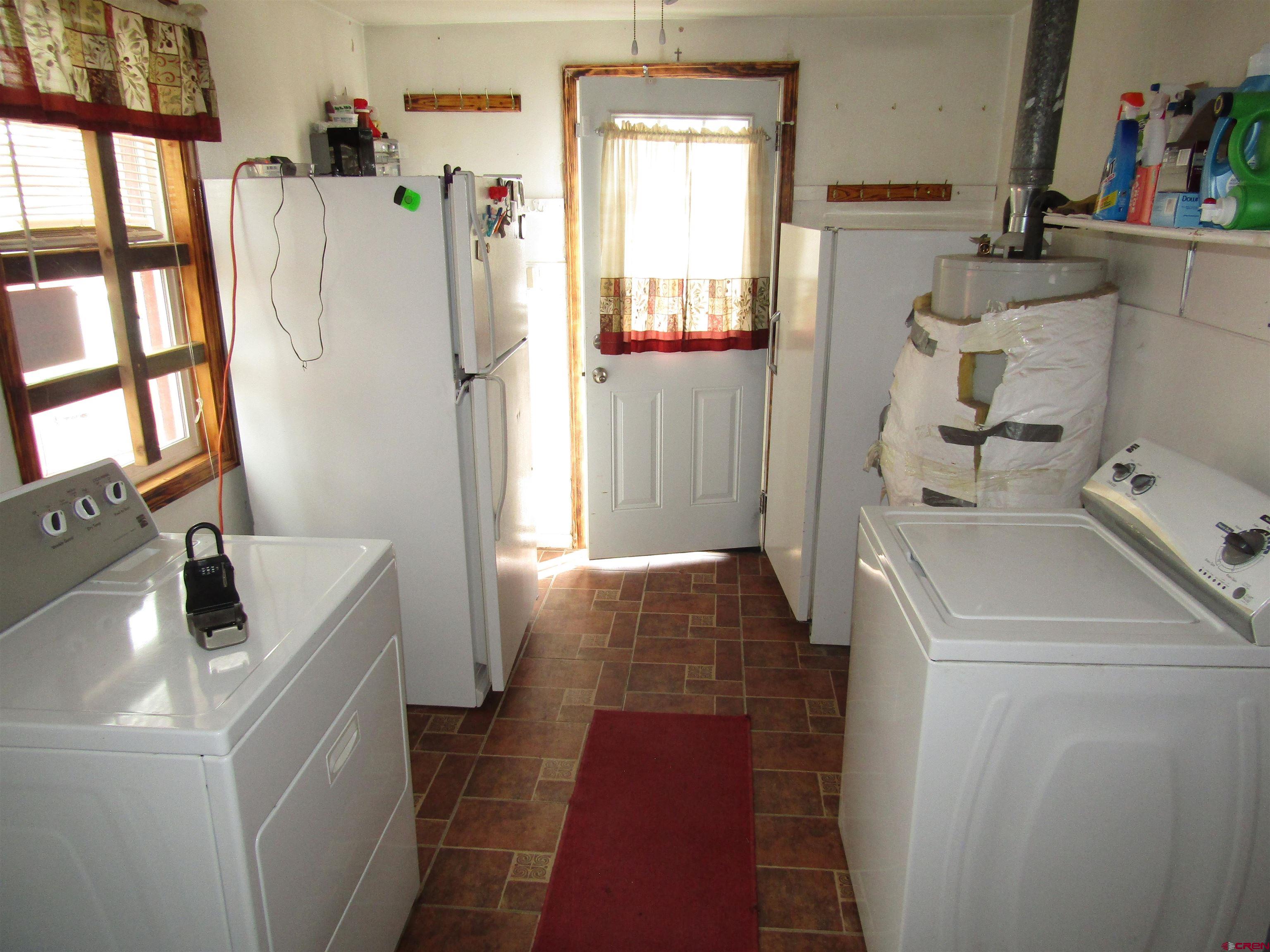 412 Lariat Road Monte Vista, CO 81144 - Photo 10 of 12 a room with a washer and dryer next to a window