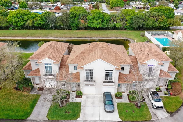 an aerial view of a house with a yard