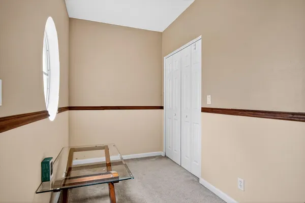 a view of a room with wooden floor and white walls