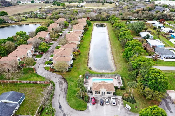 an aerial view of a house with a yard and lake view