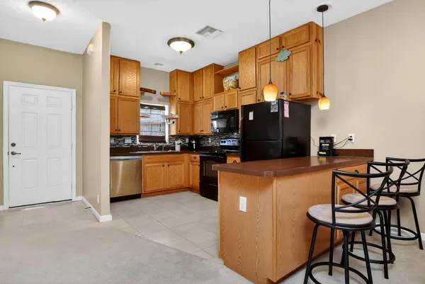 a kitchen with stainless steel appliances a refrigerator a stove a sink and a microwave