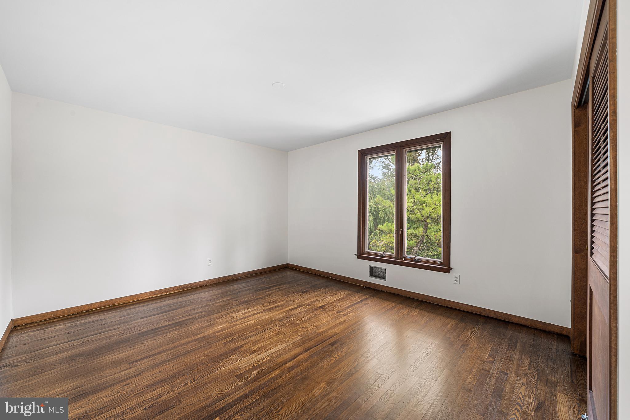 204 French Road Newtown Square, PA 19073 - Photo 22 of 36 an empty room with wooden floor and windows