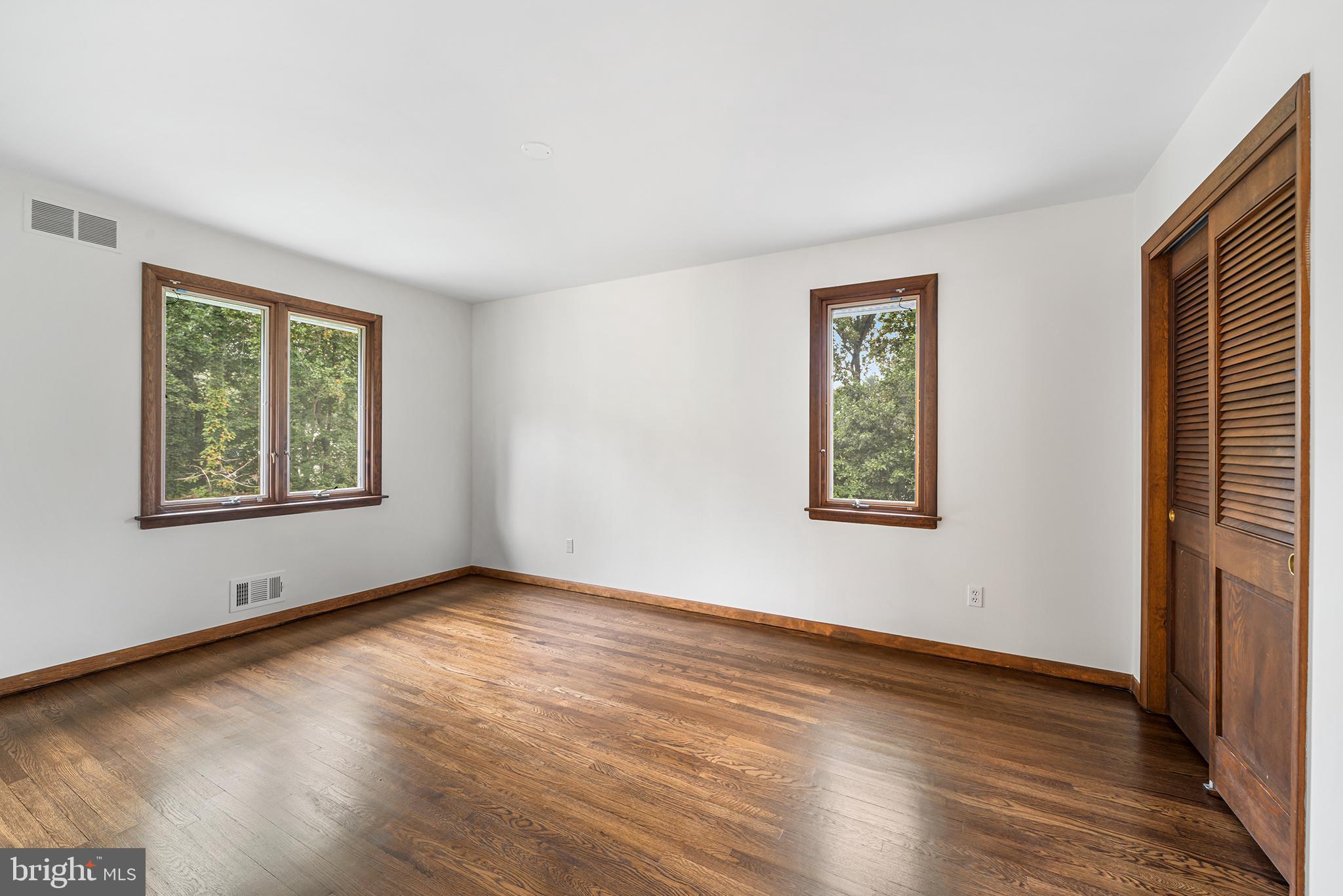 204 French Road Newtown Square, PA 19073 - Photo 23 of 36 an empty room with wooden floor and windows