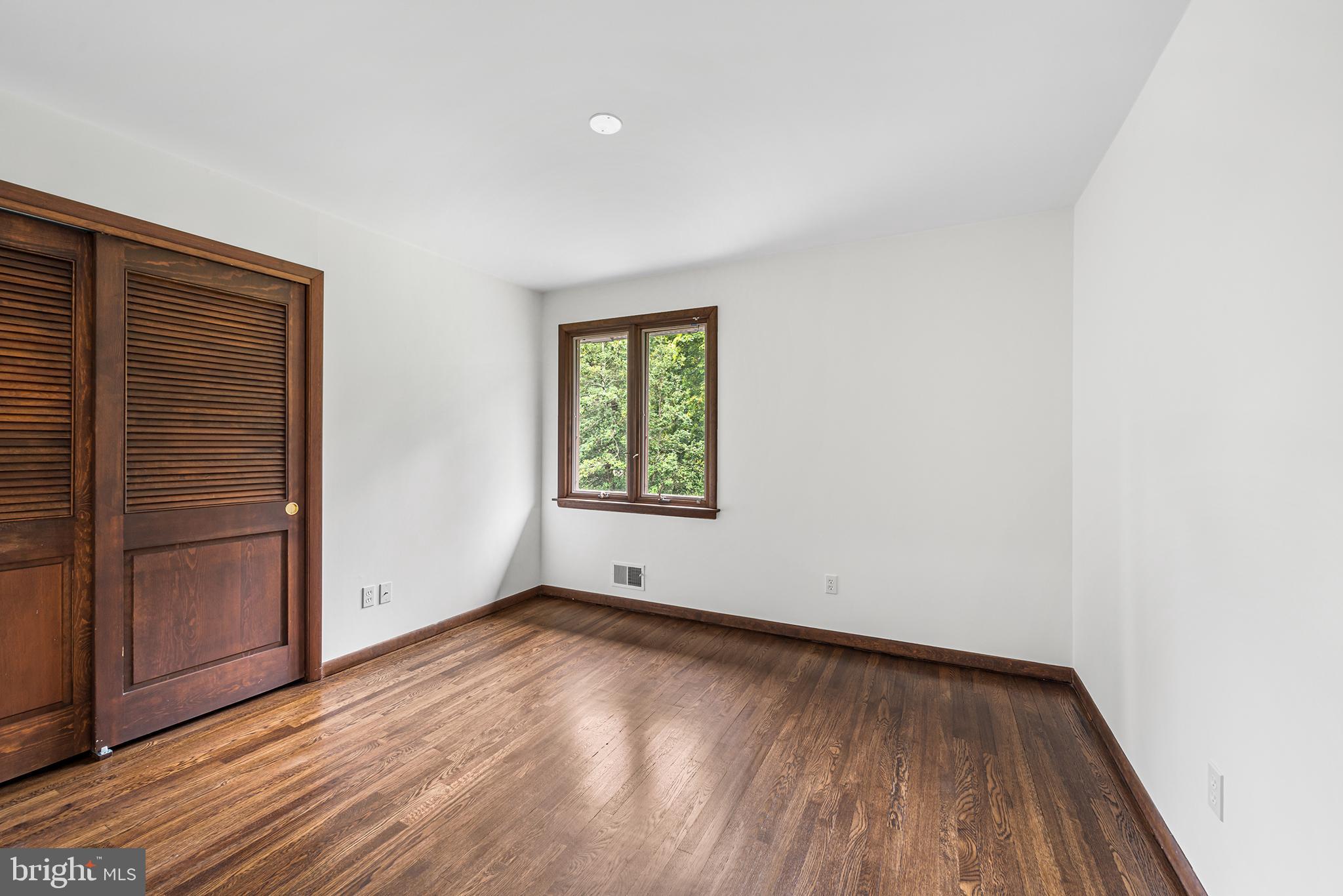 204 French Road Newtown Square, PA 19073 - Photo 24 of 36 an empty room with wooden floor and windows