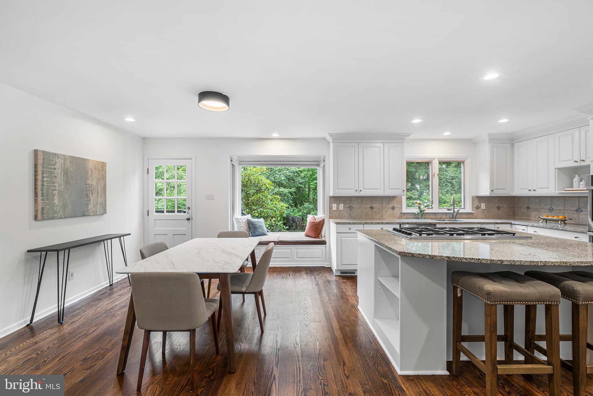204 French Road Newtown Square, PA 19073 - Photo 9 of 36 a kitchen with a table chairs stove and wooden floor