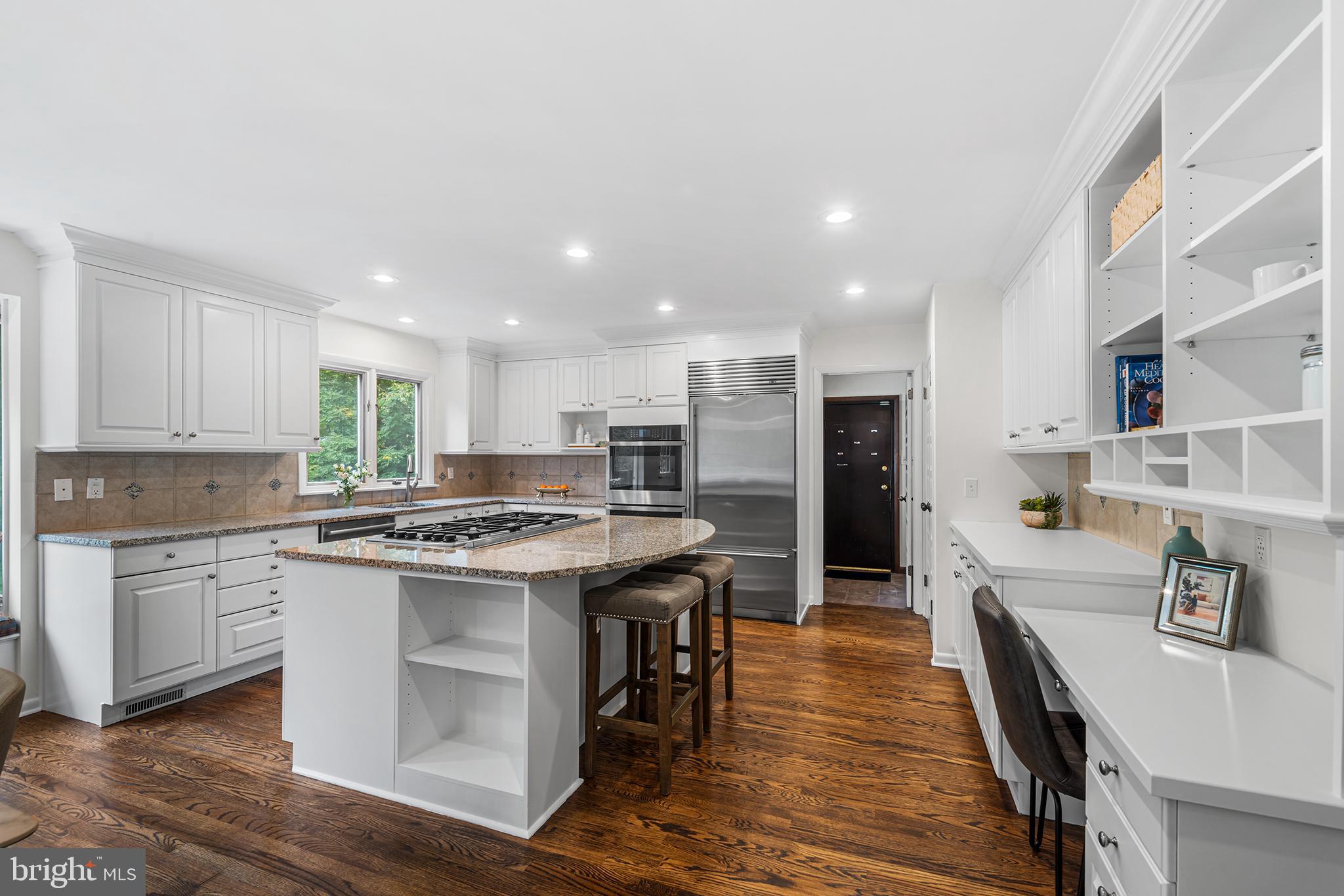204 French Road Newtown Square, PA 19073 - Photo 10 of 36 a kitchen with kitchen island granite countertop wooden floors and white cabinets