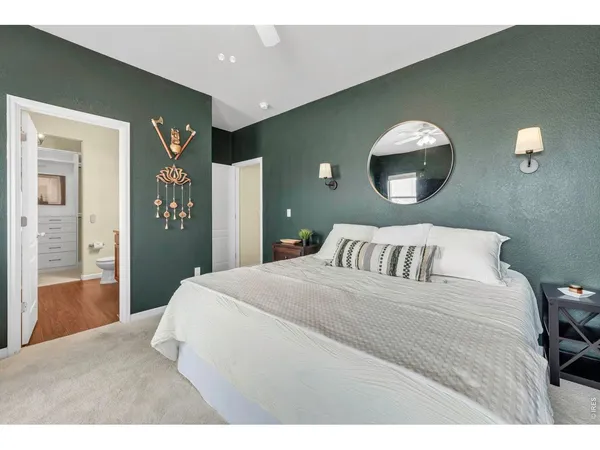 a bedroom with a bed and a mirror