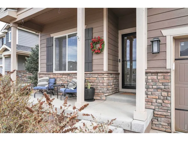 a front view of a house with outdoor seating