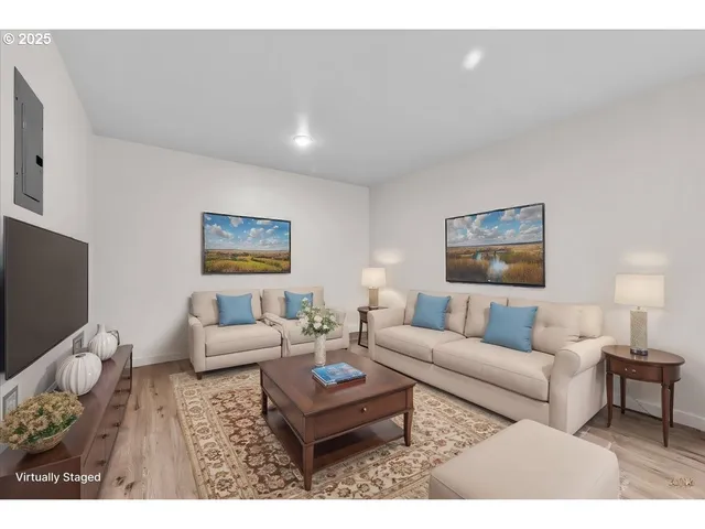 a living room with furniture a flat screen tv and a wall