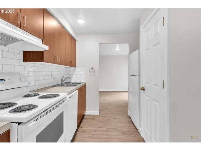 a kitchen with a stove and a refrigerator