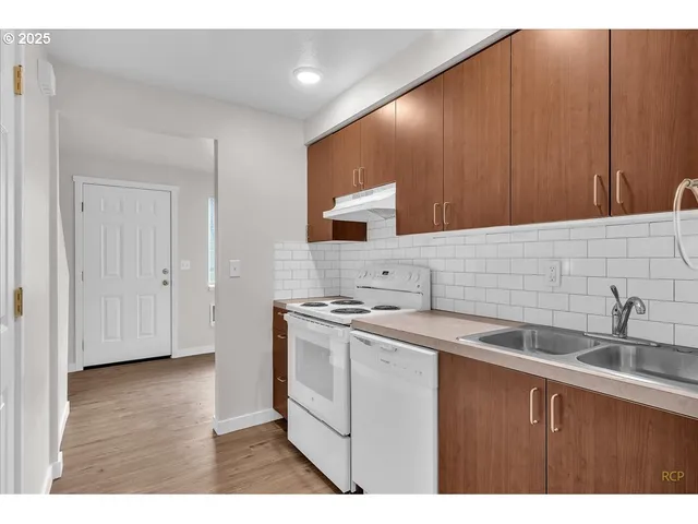 a kitchen with a sink cabinets and stainless steel appliances