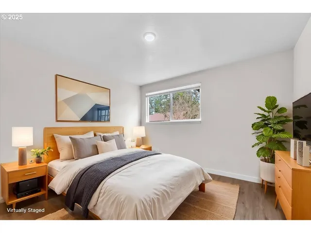 a bedroom with a bed and a potted plant