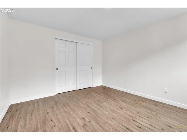 a view of an empty room and wooden floor