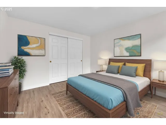 a bedroom with a bed and a painting on the wall