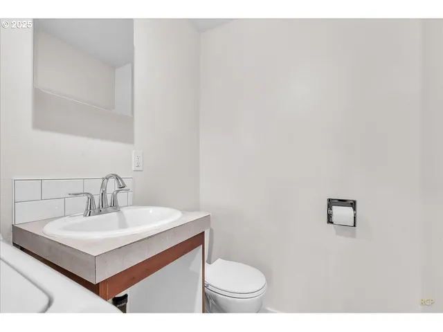 a bathroom with a sink toilet and mirror