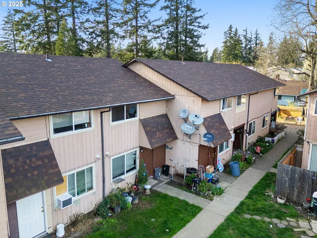 a aerial view of a house next to a yard