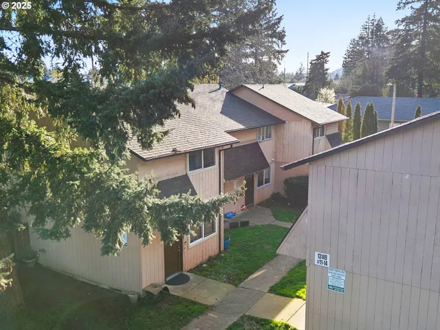 a view of a house with a wooden fence