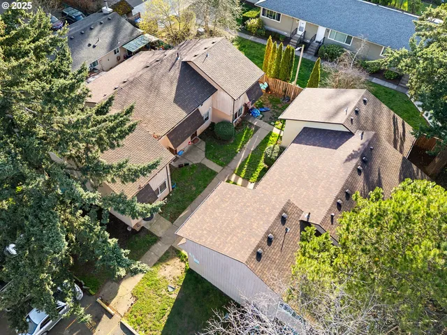 an aerial view of a house with a yard