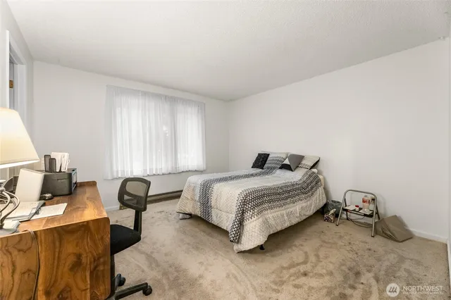 a bedroom with a bed and a chair