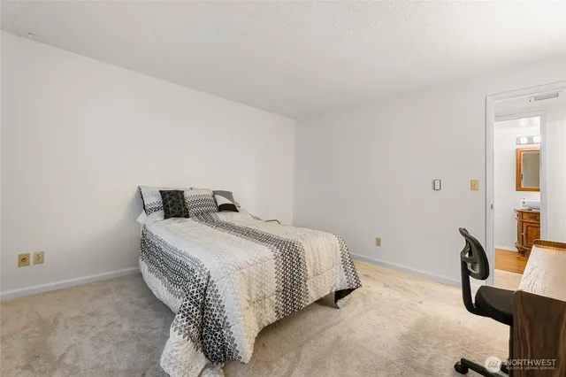 a bedroom with a bed and a chair