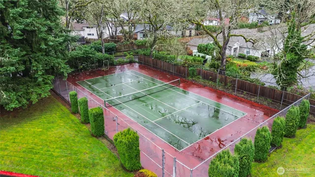 an aerial view of a house with swimming pool and outdoor seating