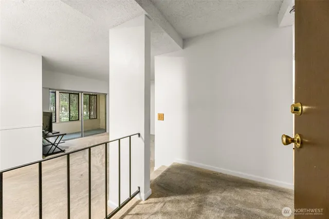 a view of a hallway with wooden floor and entryway