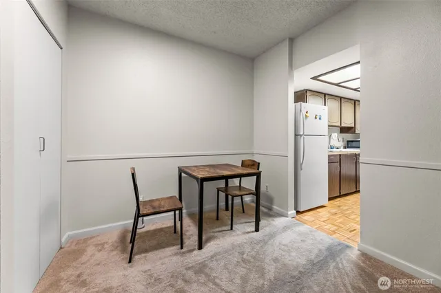 a view of kitchen with furniture and refrigerator