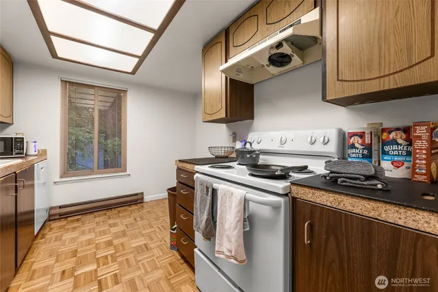 a kitchen with stainless steel appliances granite countertop a stove and a sink