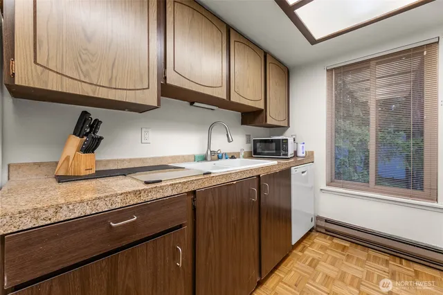 a kitchen with granite countertop cabinets stainless steel appliances and a sink
