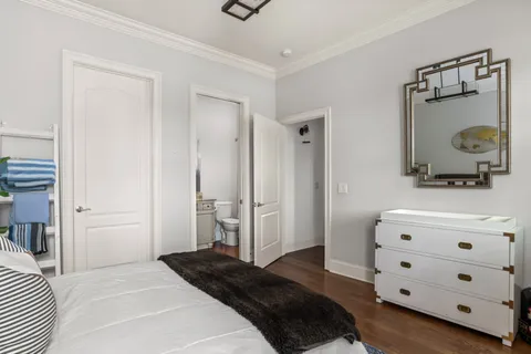 a living room with hard wood floor a rug and a window