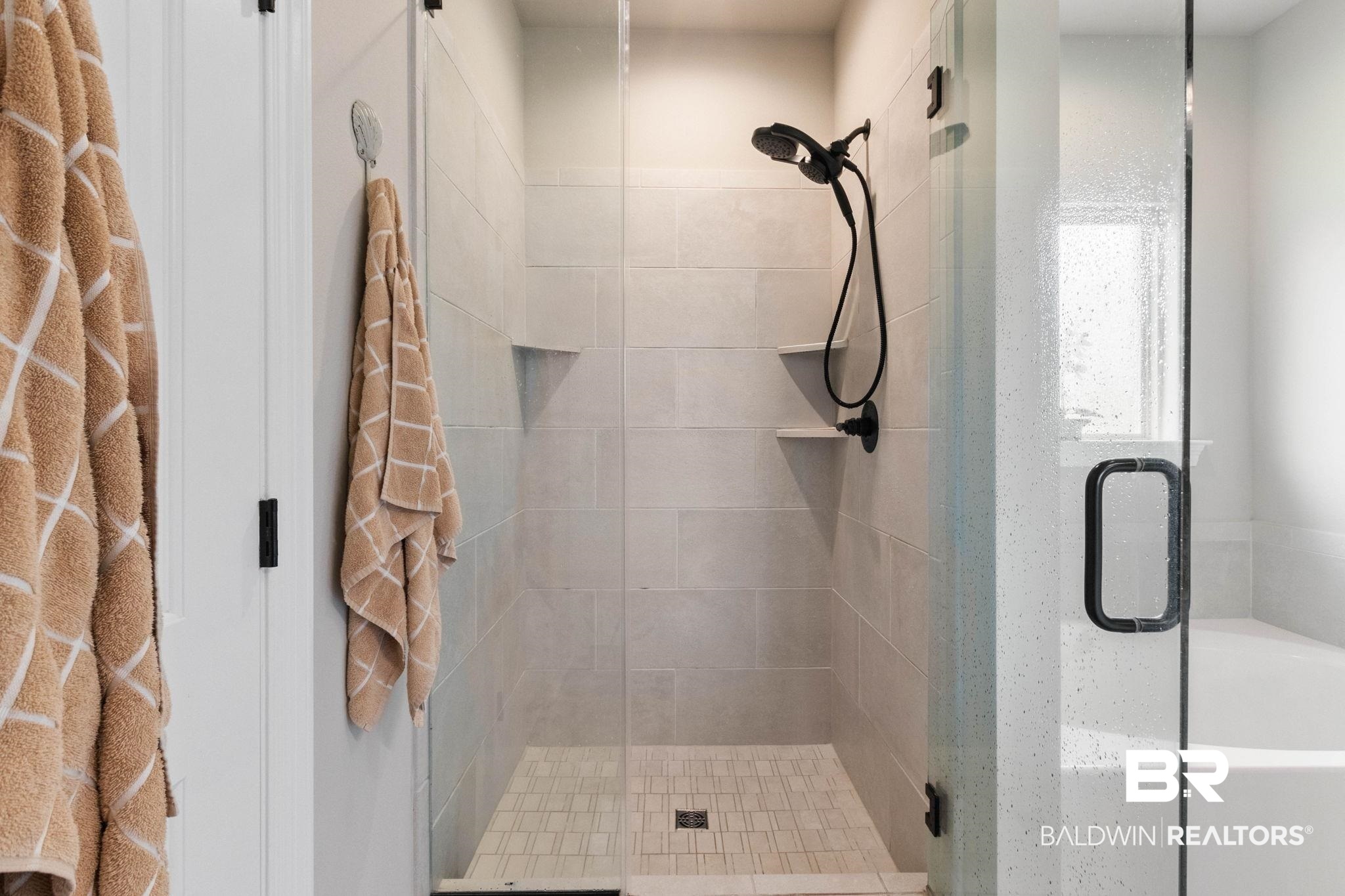 22244 Hibiscus Circle Foley, AL 36535 - Photo 46 of 51 Glass-enclosed shower featuring light-toned subway tile walls, a tiled shower pan, matte black fixtures, and integrated corner shelves