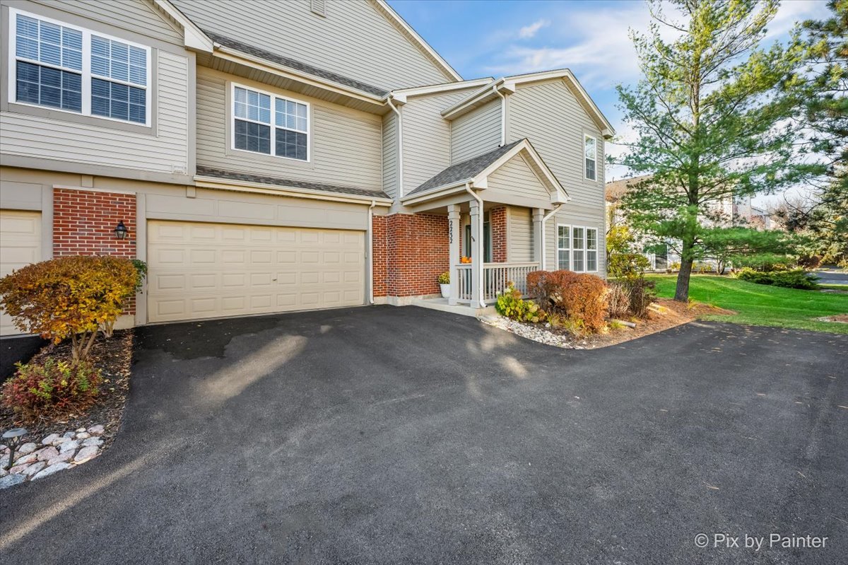 a view of a house with a yard and garage