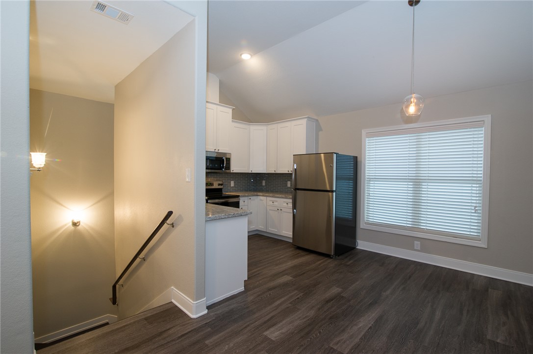 701 Hereford Street, Unit GARAGE APARTMENT College Station, TX 77840 - Photo 8 of 14 a kitchen with stainless steel appliances a refrigerator and wooden floor