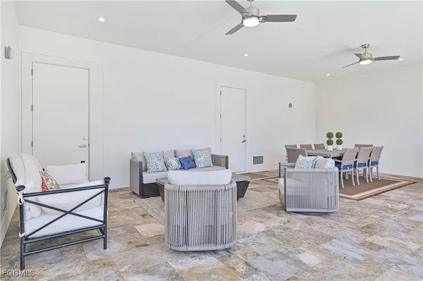 a living room with couches and kitchen view