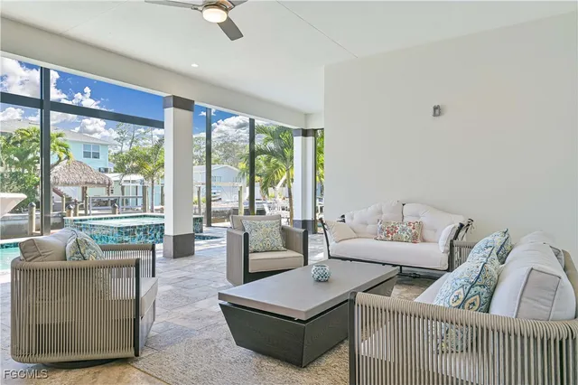 a living room with furniture and a floor to ceiling window