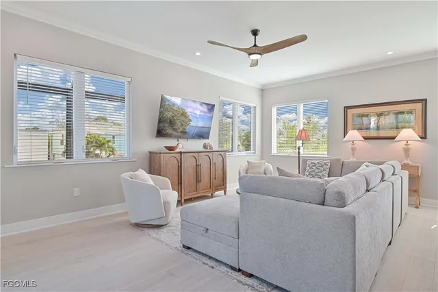 a living room with furniture a large window and a flat screen tv