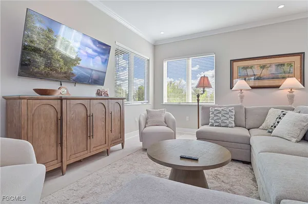 a living room with furniture and a large window