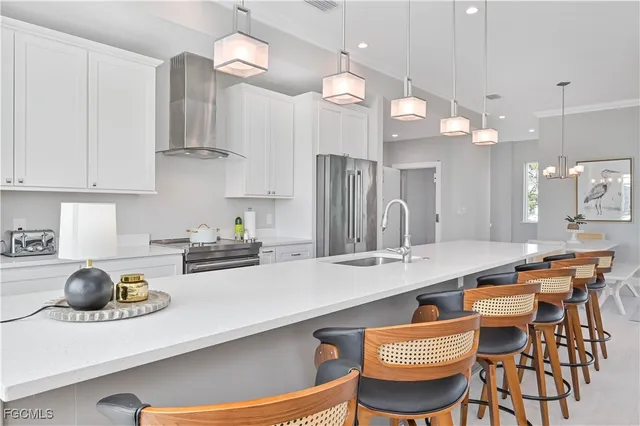 a kitchen with stainless steel appliances granite countertop a sink a stove and a refrigerator