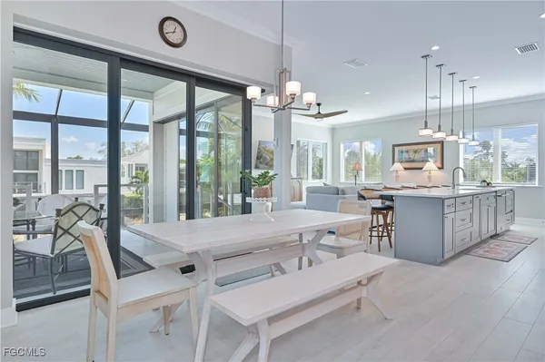 a living room with furniture a large window and chandelier