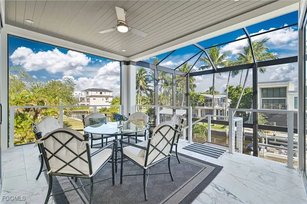 a view of a dining room with furniture large windows and wooden floor